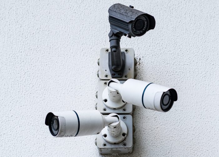 Security cameras on white modern building, technology concept